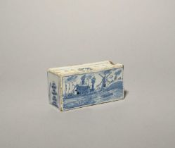 A small Liverpool delftware flower brick, c.1750, the rectangular form painted in blue with a