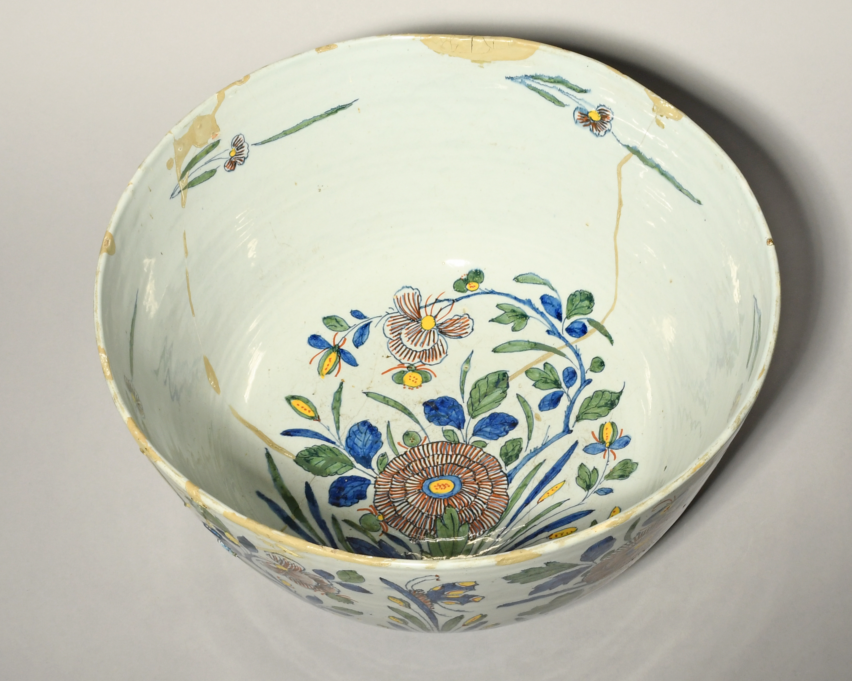A massive Delft punch bowl, 18th century, boldly painted in polychrome enamels with flowering plants - Image 3 of 3