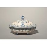 A large Moustiers faïence tureen and cover, c.1750, the shallow form raised on four paw feet and