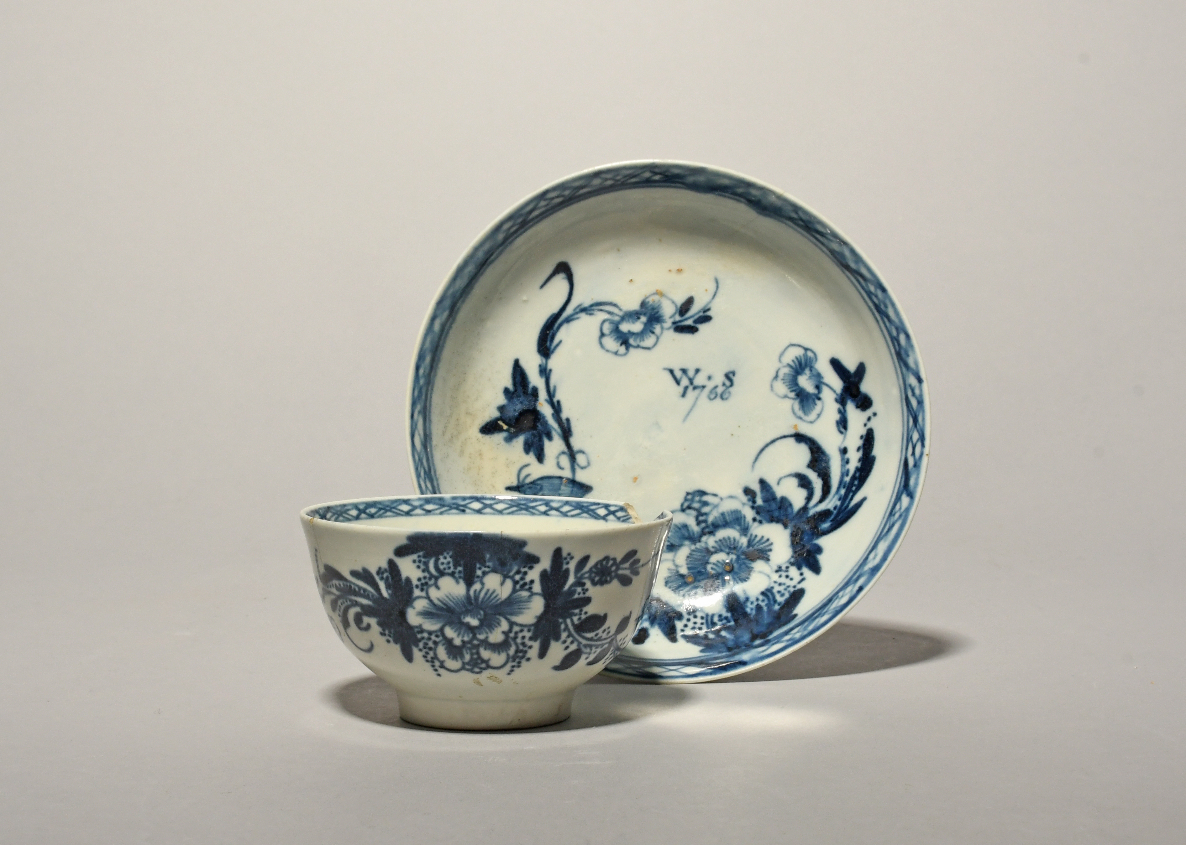 A Richard Chaffers (Liverpool) blue and white teabowl and saucer, dated 1766, painted with a small - Image 2 of 3