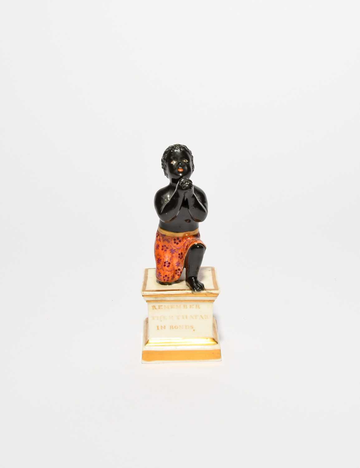 A rare Derby anti-slavery figure, early 19th century, modelled as a young black slave on one knee