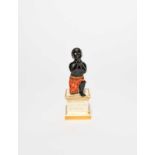 A rare Derby anti-slavery figure, early 19th century, modelled as a young black slave on one knee