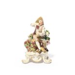 A Bow figure of Autumn from the Rustic Seasons, c.1765, seated on a large basket of grapes and