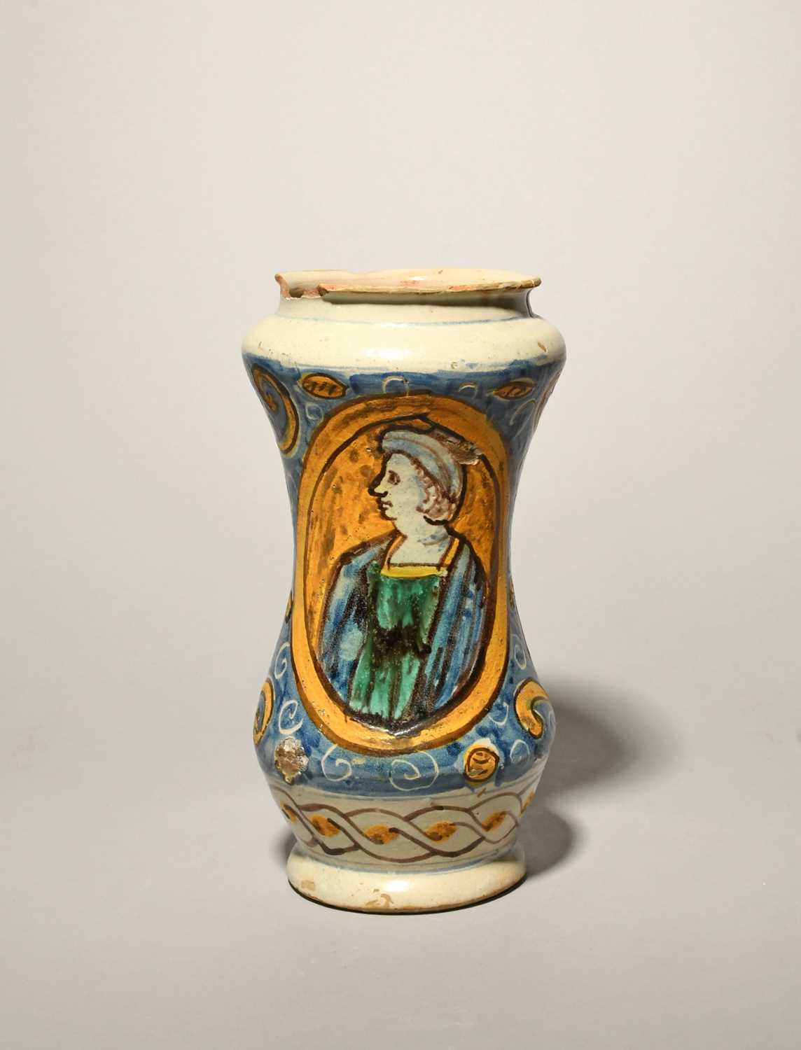 A Sicilian maiolica albarello, late 17th century, the waisted form painted in blue, green, yellow