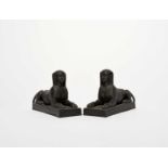 A pair of Wedgwood black basalt figures of sphinxes, 19th century, recumbent on rectangular bases