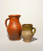 A rare post-medieval redware jug, 16th century, the rounded body with a pulled spout, incised with