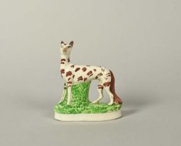 A Staffordshire figure of a fox, 19th century, standing with head turned to the left, its coat