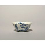 A small Longton Hall blue and white bowl, c.1755-60, well painted with a Chinese figure seated by