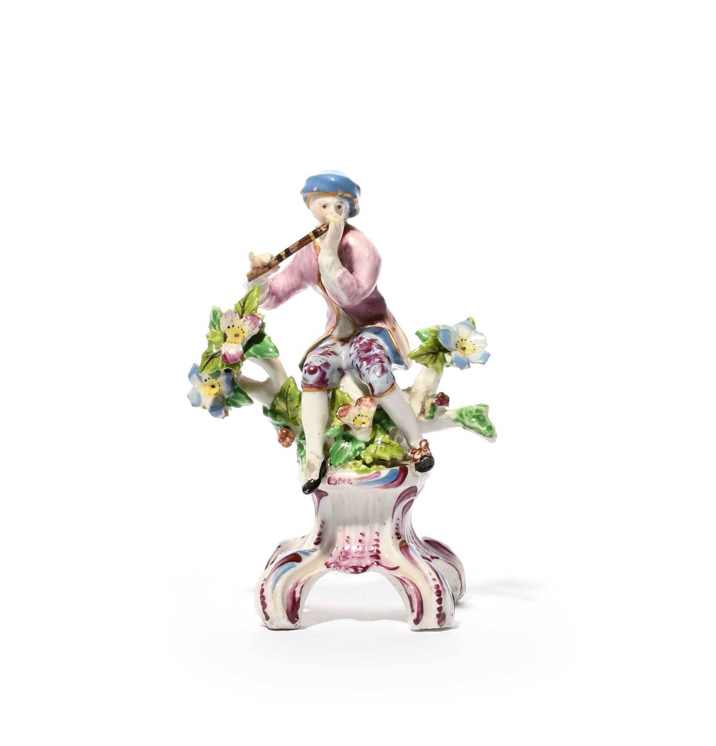 A small or miniature Bow figure of a musician, c.1760-65, seated on a stump between flowering