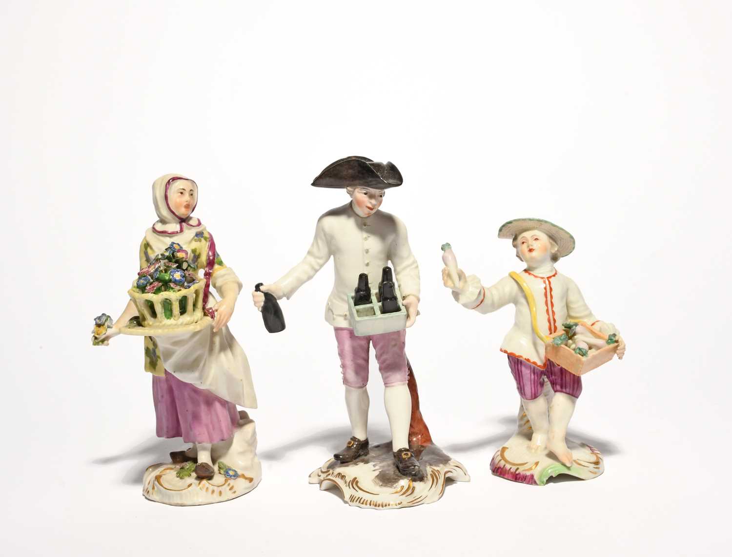 Three German porcelain figures of traders, 18th century, one Frankenthal of a beer seller,