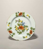 A Liverpool delftware large plate, c.1760, painted in the Fazackerly palette with a central