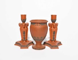 A pair of Wedgwood 'Rosso Antico' candlesticks, 19th century, the sconces raised on columns
