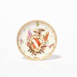 A rare Cozzi armorial saucer, c.1760-70, painted with a red and white striped shield flanked by