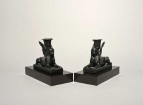 A pair of Wedgwood black basalt sphinx candlesticks, 19th century, each modelled as a recumbent
