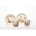 A rare Nymphenburg coffee cup and saucer, dated 1757, the cup painted with three figures beneath a