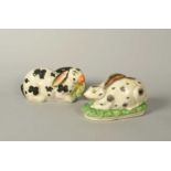 Two large Staffordshire figures of rabbits, c.1860 and later, one recumbent on a grassy base with