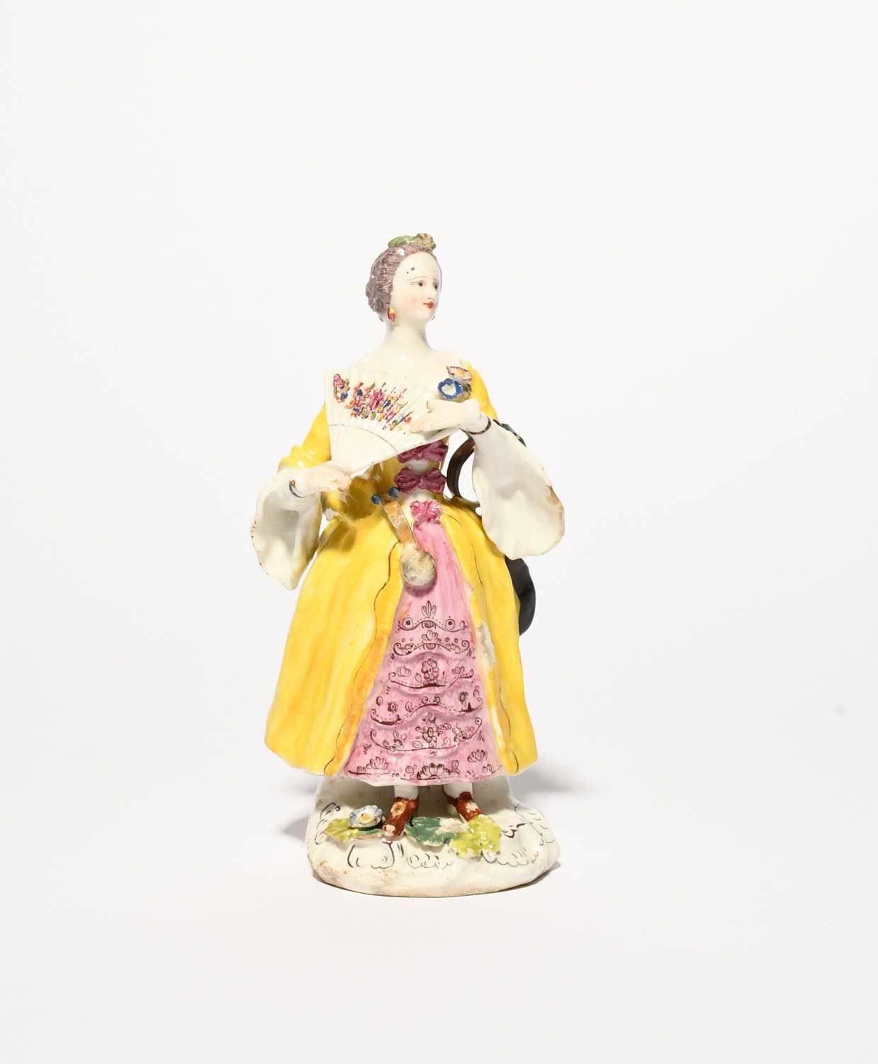 A rare Bow figure of a lady, c.1758, after a Meissen model by Peter Reinicke, wearing a layered