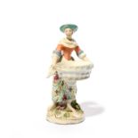 A Chelsea sweetmeat figure of a girl, c.1760, modelled as a barefoot peasant girl carrying a large