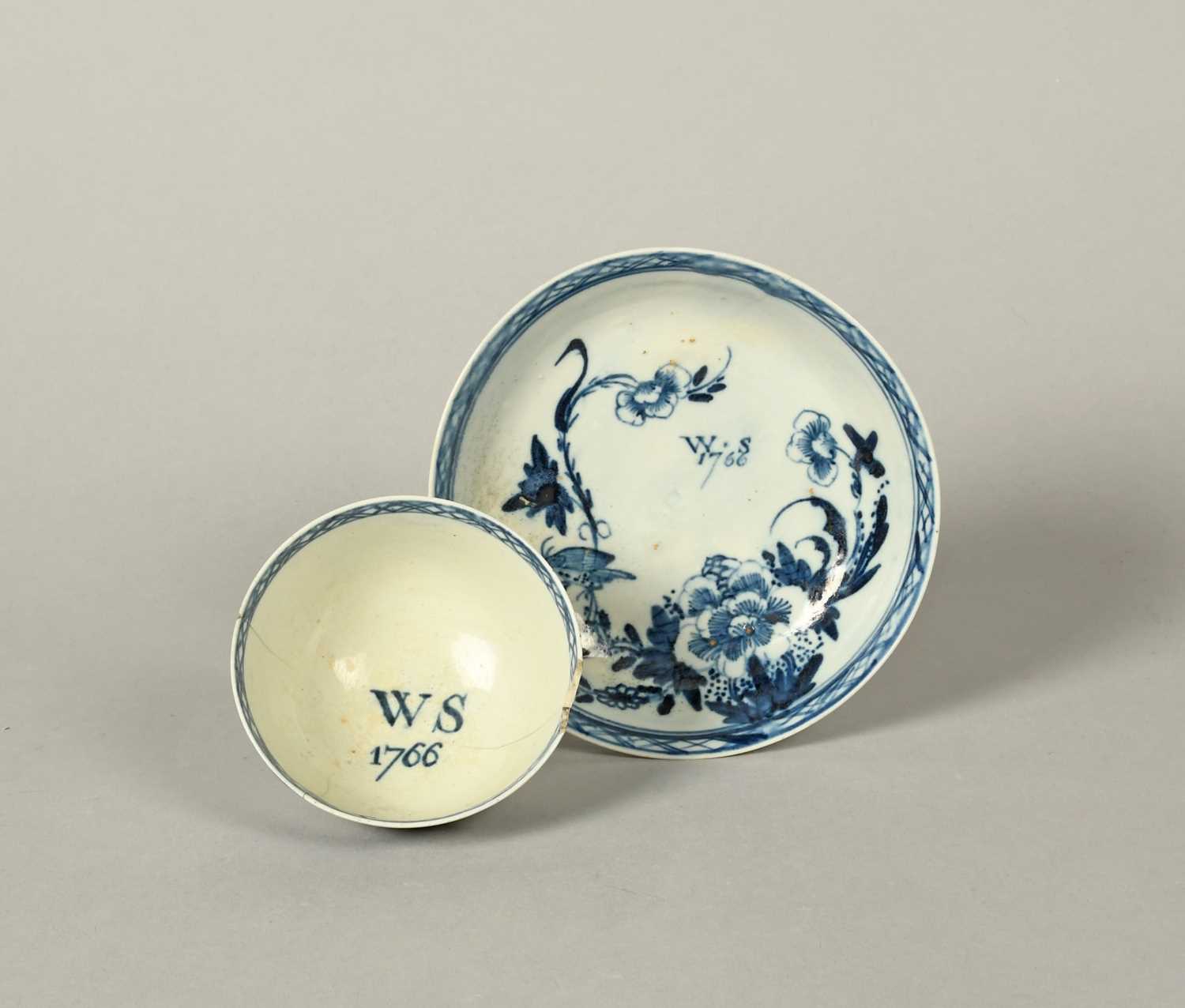 A Richard Chaffers (Liverpool) blue and white teabowl and saucer, dated 1766, painted with a small