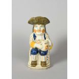 A Pratt ware 'Convict' Toby jug, c.1800, seated with a foaming jug of ale on his left knee,