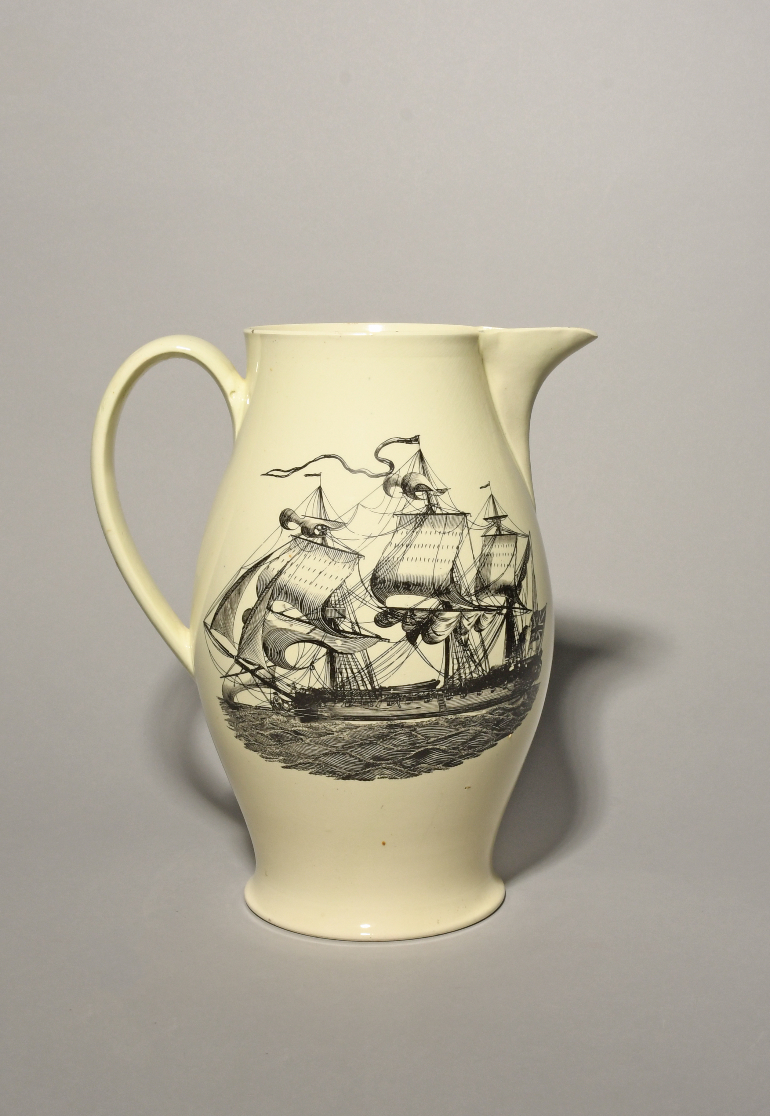 A large creamware jug, c.1795-1800, printed to one side with a sailor and two companions seated in a - Image 2 of 2