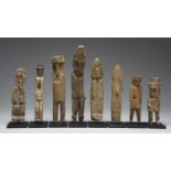 Eight Kuna figuresSan Blas Islands, Panamaall standing and with beak like noses, one wearing a tie