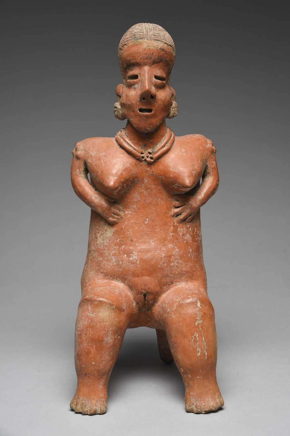 A Nayarit seated female figureMexico, circa 100 BC - 250 ADpottery, with a linear incised coiffure