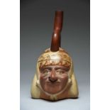 A Moche stirrup spout portrait head vessel