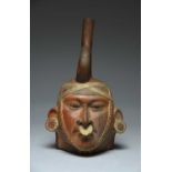 A Moche stirrup spout portrait head vessel