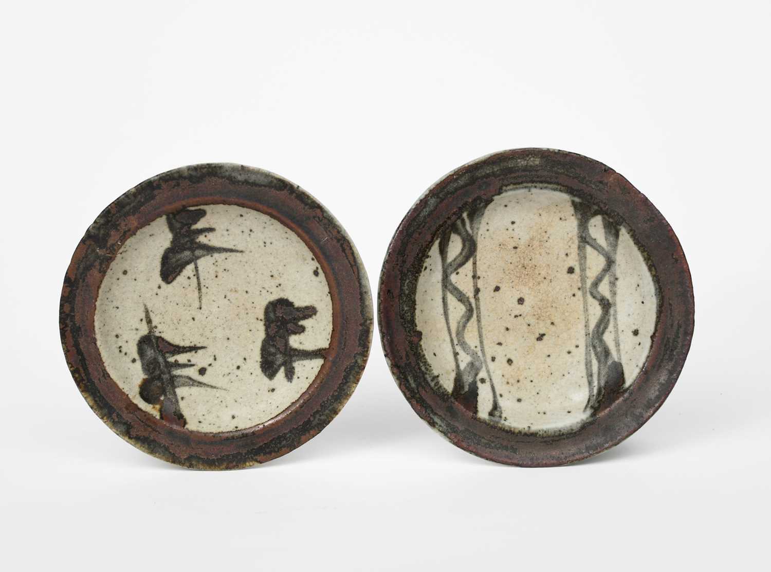 Shoji Hamada (1894-1978), attributed a pair of stoneware dishes, each with painted brush design in