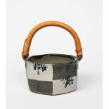 ‡ John Maltby (1936-2020)a stoneware basket with bamboo handle, enamelled with cobalt flower