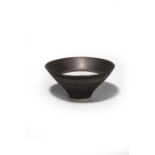 ‡ Dame Lucie Rie (1902-1995) conical porcelain bowl, covered with a manganese glaze, the interior