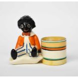 'Golly' a rare Clarice Cliff Bizarre pen-holder, modelled as a toy golly seated next to a