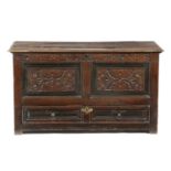 AN OAK MULE CHEST LATE 17TH / EARLY 18TH CENTURY the twin panelled front carved with scrolling