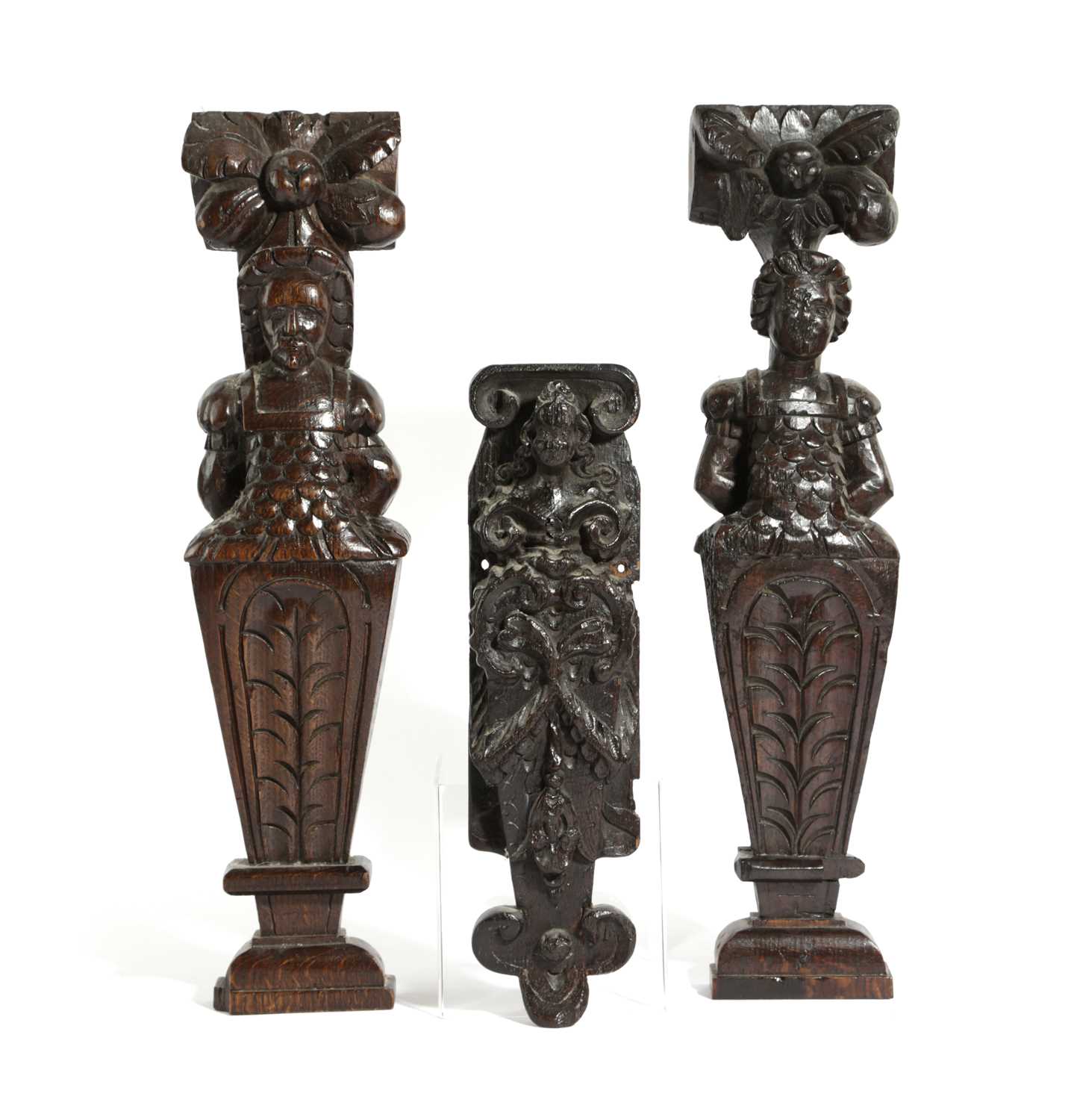 A PAIR OF OAK TERMS 17TH CENTURY the male and female busts beneath large flowers, with carved bodies