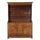 A GEORGE III WELSH OAK DRESSER LATE 18TH CENTURY the plate rack with a shaped apron and inscribed '
