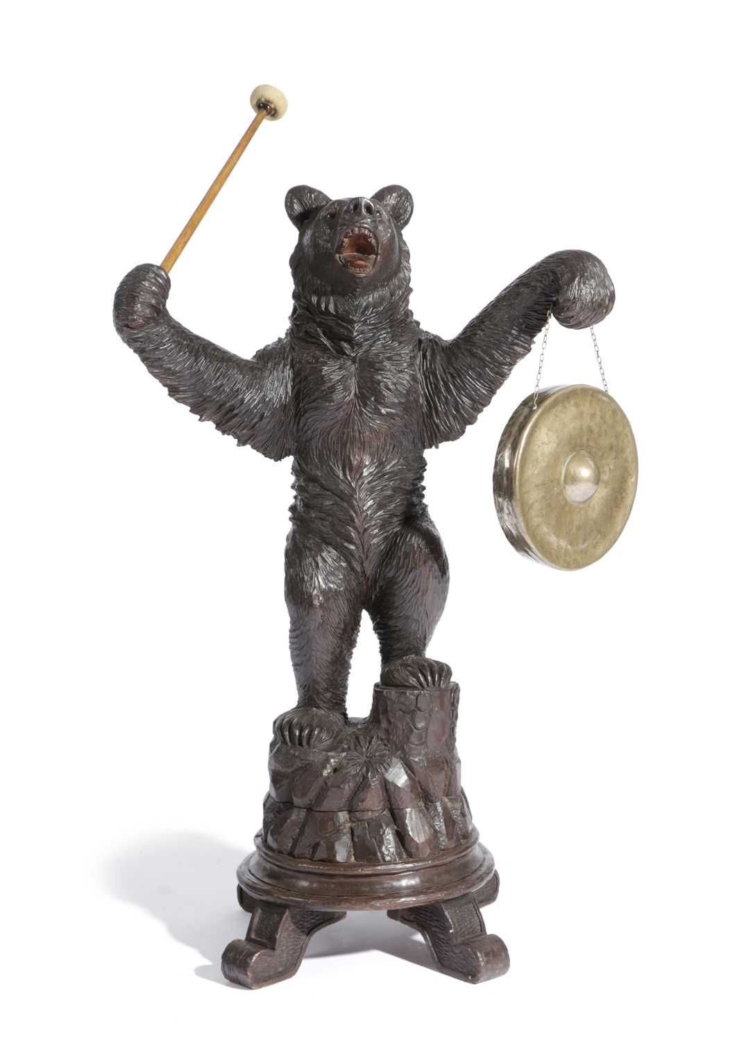 A BLACK FOREST LINDEN WOOD BEAR GONG LATE 19TH CENTURY modelled standing, mouth open, with a brass