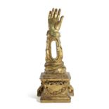 A SPANISH GILTWOOD RELIQUARY 18TH CENTURY in the form of an arm, inset with a glass panel and on a