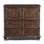 A CHARLES II OAK CHEST C.1680 in two halves of three long geometric panelled drawers with applied