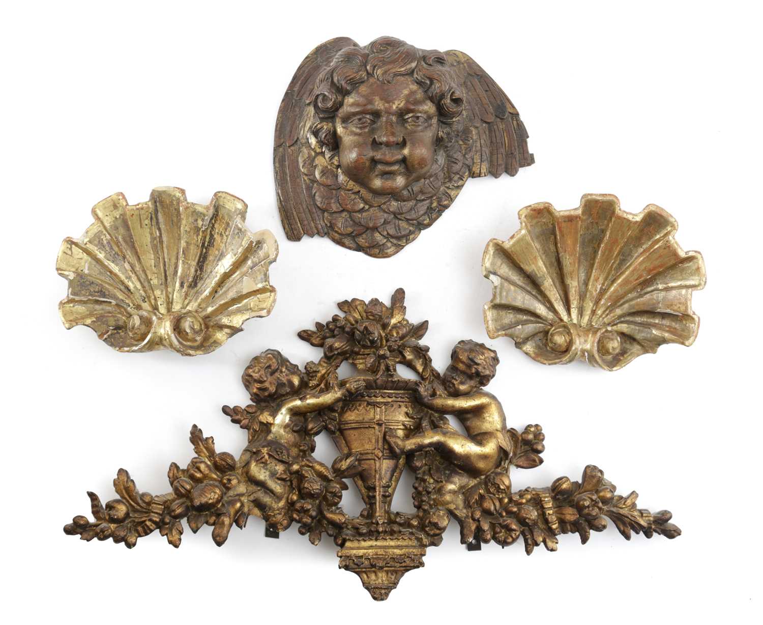 A PAIR OF GILTWOOD SCALLOP SHELL APPLIQUES 18TH CENTURY together with a carved and gilded cherub's