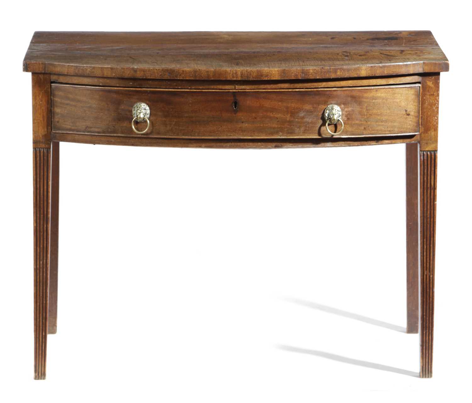 A REGENCY MAHOGANY BOWFRONT SIDE TABLE EARLY 19TH CENTURY with a frieze drawer above ribbed square