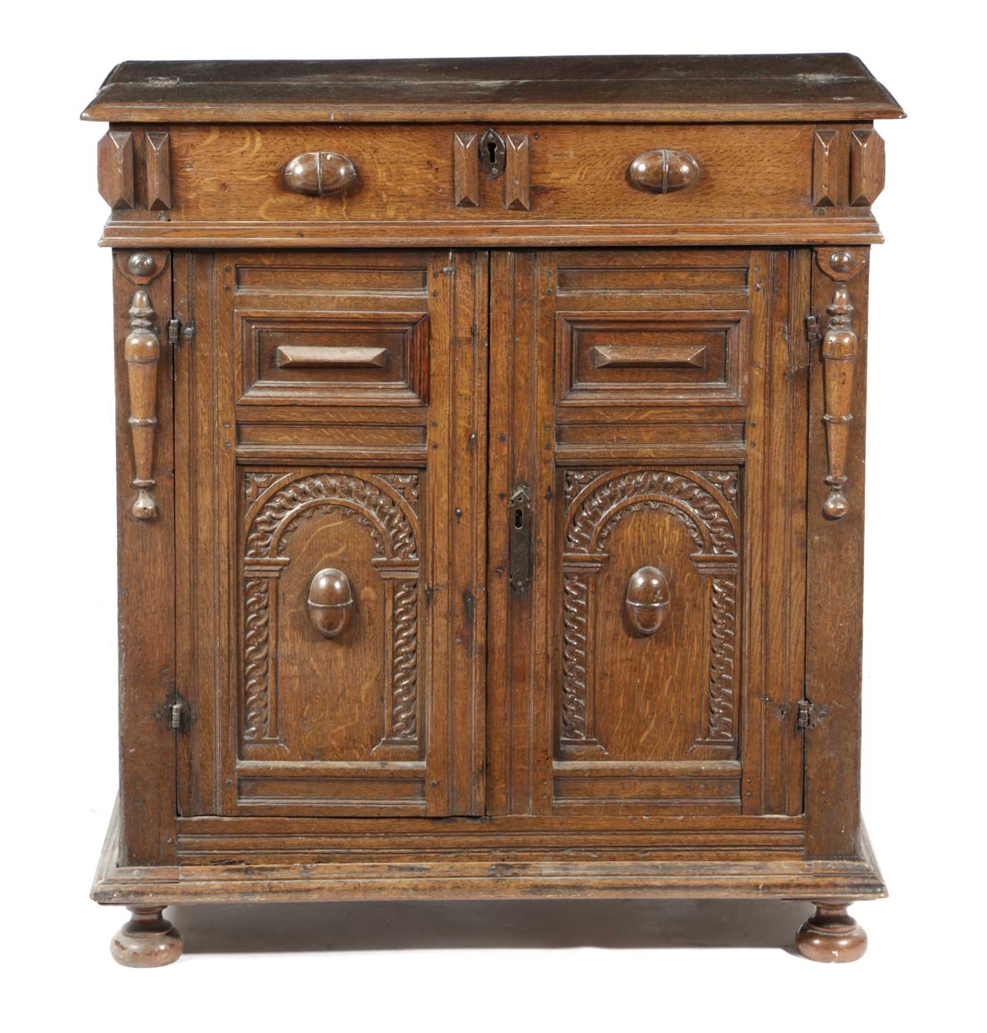 AN OAK SIDE CABINET LATE 17TH CENTURY the twin hinged top revealing a vacant interior, the front