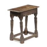 AN OAK JOINT STOOL IN ELIZABETH I STYLE with a zigzag moulded band above a pierced shallow