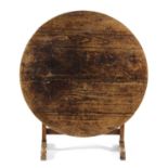 A FRENCH PINE AND FRUITWOOD WINE TASTING OR VENDANGE TABLE 19TH CENTURY the circular tilt-top on a