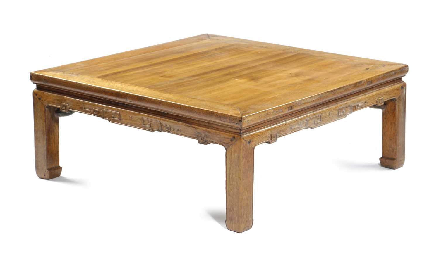 A CHINESE ELM MAHJONG OR LOW TABLE the panelled top above a key-carved frieze 37cm high, 91cm