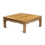 A CHINESE ELM MAHJONG OR LOW TABLE the panelled top above a key-carved frieze 37cm high, 91cm