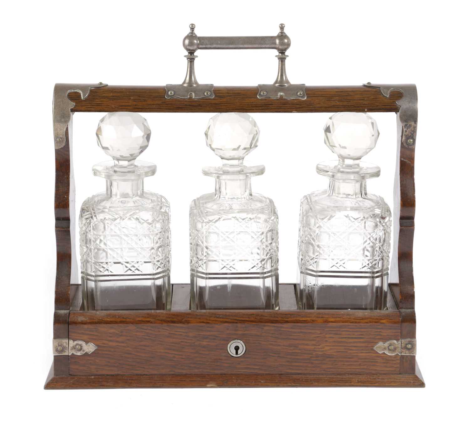 A VICTORIAN OAK AND SILVER PLATED MOUNTED TANTALUS LATE 19TH CENTURY with Gothic style mounts,