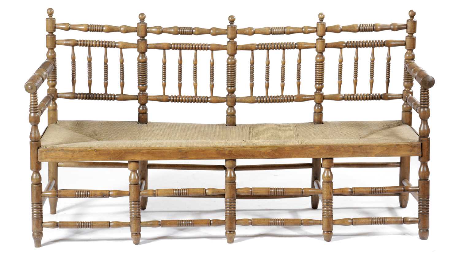 A FRENCH BEECHWOOD SPINDLE BACK SETTEE LATE 19TH CENTURY with ring turned decoration, the rush