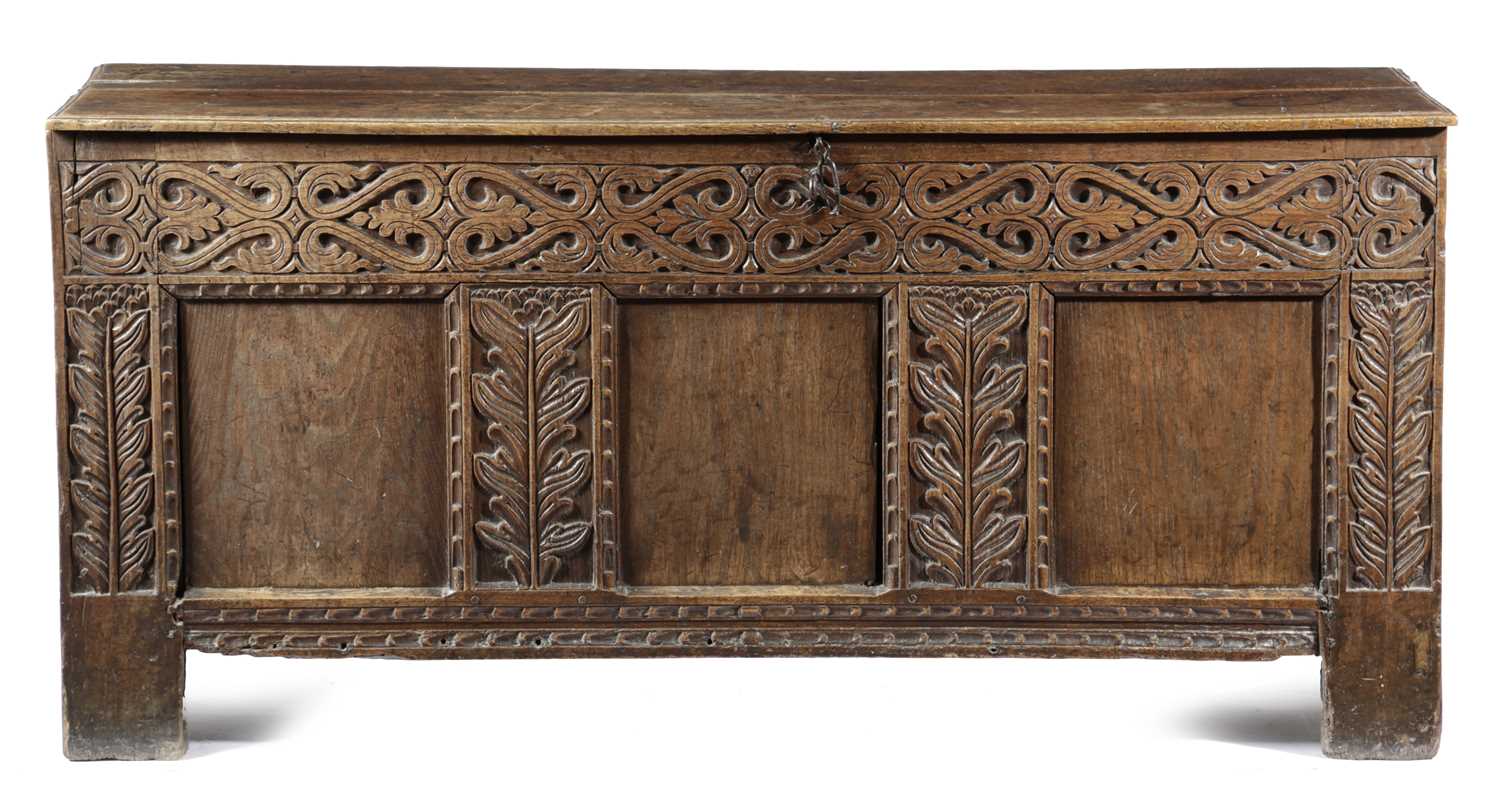 AN OAK COFFER 17TH CENTURY AND LATER the triple panelled front carved with scrolls and leaves 67.7cm