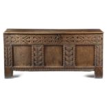 AN OAK COFFER 17TH CENTURY AND LATER the triple panelled front carved with scrolls and leaves 67.7cm